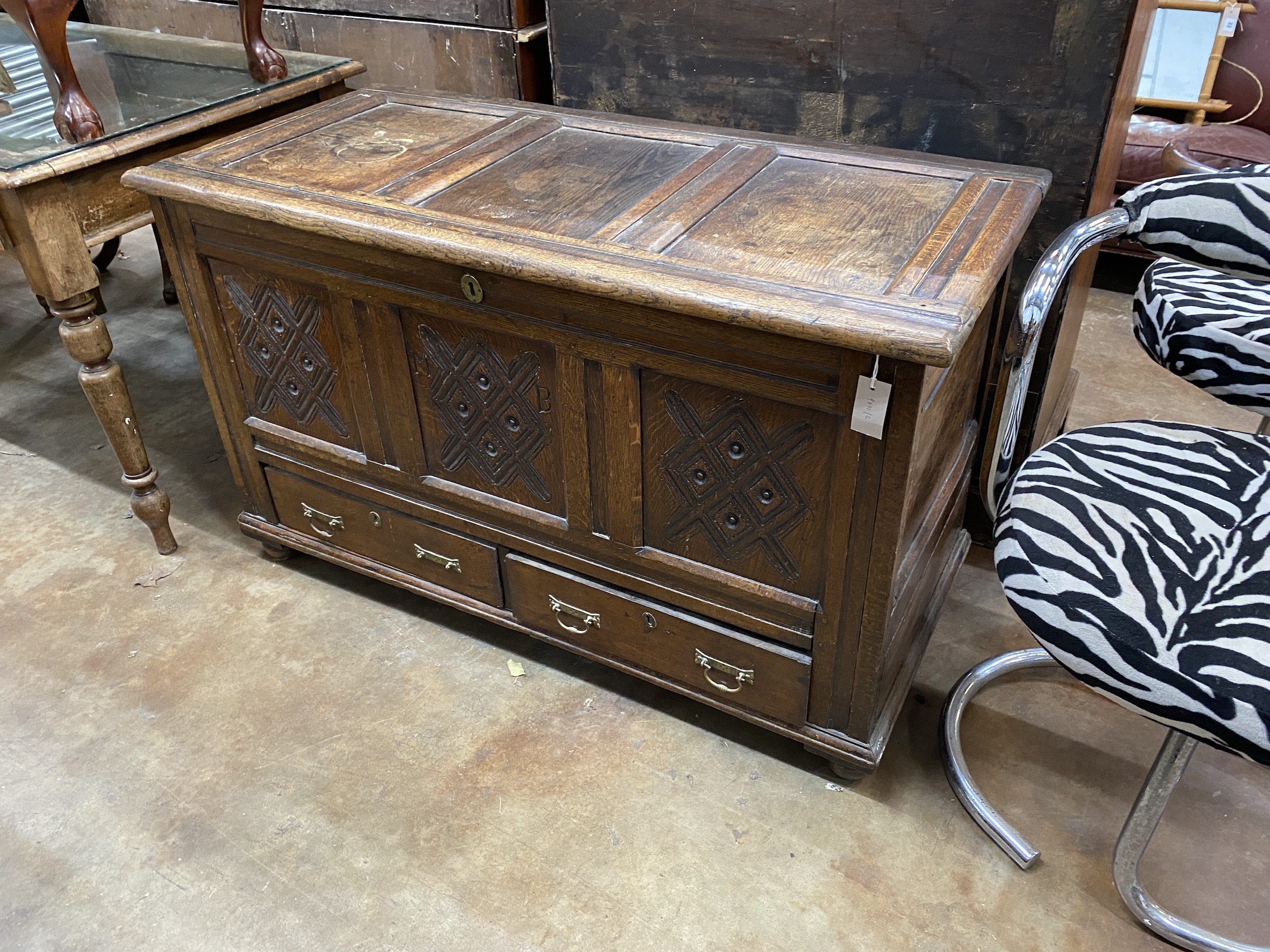 An 18th century panelled oak mule chest, width 122cm, depth 57cm, height 74cm